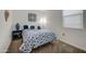 Cozy bedroom featuring carpet floors, a blue-and-white floral bedspread, and decorative accents at 3353 W Shanley Ave, Apache Junction, AZ 85120