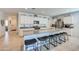 Spacious eat-in kitchen featuring a granite-topped island with seating and white cabinetry at 3353 W Shanley Ave, Apache Junction, AZ 85120