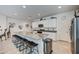 Bright eat-in kitchen featuring a granite-topped island with seating, and stainless appliances at 3353 W Shanley Ave, Apache Junction, AZ 85120