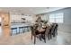 Bright, open kitchen/dining area with white cabinets, granite counters, and a large dining table at 3353 W Shanley Ave, Apache Junction, AZ 85120