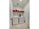 Functional laundry room with white appliances, shelving, and tiled flooring at 3353 W Shanley Ave, Apache Junction, AZ 85120