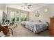 Bright bedroom with neutral tones, two twin beds, carpet, and a ceiling fan, providing a relaxing atmosphere at 3567 E Sierra Madre Ave, Gilbert, AZ 85296