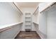 Walk-in closet with built-in shelving and rods for hanging clothes with wood-look flooring at 38408 N 23Rd Dr, Phoenix, AZ 85086