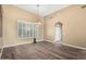 Bright dining room with wood floors, plantation shutters, and modern light fixture at 38408 N 23Rd Dr, Phoenix, AZ 85086