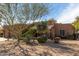 Exterior view of the property featuring lush desert landscaping and well-manicured front yard at 38408 N 23Rd Dr, Phoenix, AZ 85086