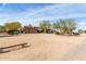 Exterior view of the property featuring a three-car garage, desert landscaping, and large lot at 38408 N 23Rd Dr, Phoenix, AZ 85086