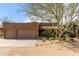 Home exterior showcasing a three-car garage, desert landscaping, and a well-maintained facade at 38408 N 23Rd Dr, Phoenix, AZ 85086