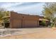 Exterior view of the property featuring a three-car garage, desert landscaping, and a well-manicured lawn at 38408 N 23Rd Dr, Phoenix, AZ 85086