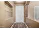 Light foyer featuring hardwood floors, built-in shelving, and a modern front door at 38408 N 23Rd Dr, Phoenix, AZ 85086
