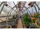 Greenhouse interior featuring rows of plants in metal containers with overhead lighting at 38408 N 23Rd Dr, Phoenix, AZ 85086