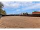 Large horse arena with sand surface, horse stalls, metal fencing, and a view of the neighborhood at 38408 N 23Rd Dr, Phoenix, AZ 85086
