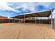 Covered horse stall with metal frame, sand floor, and metal gating offering shaded space for livestock at 38408 N 23Rd Dr, Phoenix, AZ 85086
