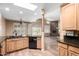 Bright kitchen featuring granite countertops, wood cabinets, and an open view to a stone fireplace in the living area at 38408 N 23Rd Dr, Phoenix, AZ 85086