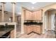 Bright kitchen with wood cabinets, granite countertops, and access to the living area at 38408 N 23Rd Dr, Phoenix, AZ 85086