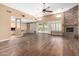 Open living room area with hardwood floors, fireplace, and sliding glass doors to backyard at 38408 N 23Rd Dr, Phoenix, AZ 85086