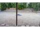 View of the backyard with a gravel ground cover, a wooden fence and a partially constructed fire pit in the center at 4110 W Cholla St, Phoenix, AZ 85029