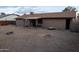 A spacious backyard features a gravel ground cover and a covered patio along the back of this one-story home at 4110 W Cholla St, Phoenix, AZ 85029