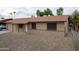 Inviting ranch-style home with a charming brick facade and well-maintained gravel yard at 4110 W Cholla St, Phoenix, AZ 85029