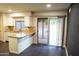 Well-lit kitchen with stone countertops, backyard access, and stainless steel sink at 4110 W Cholla St, Phoenix, AZ 85029