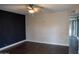 Bright living room features hardwood floors, ceiling fan, and access to the backyard at 4110 W Cholla St, Phoenix, AZ 85029