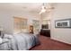 Relaxing bedroom featuring neutral walls, a ceiling fan, large window with blinds and plush carpeting at 4252 E Desert Sky Ct, Cave Creek, AZ 85331