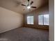 A carpeted bedroom with lots of natural light shining through the two large windows at 4252 E Desert Sky Ct, Cave Creek, AZ 85331