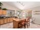 Bright kitchen with a wooden island, tile flooring, and natural light from windows and a sliding glass door at 4252 E Desert Sky Ct, Cave Creek, AZ 85331