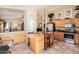 Open-concept kitchen flows into dining and living areas, featuring stainless steel appliances and a wooden island at 4252 E Desert Sky Ct, Cave Creek, AZ 85331