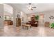 Spacious living room with tile flooring, a ceiling fan, and views of the kitchen and dining area at 4252 E Desert Sky Ct, Cave Creek, AZ 85331