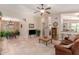 Open-concept living room featuring tile flooring, a ceiling fan, and an adjacent dining area at 4252 E Desert Sky Ct, Cave Creek, AZ 85331