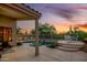 Inviting pool area with water feature and desert landscaping at dusk at 4252 E Desert Sky Ct, Cave Creek, AZ 85331