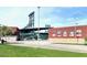 Exterior view of a baseball stadium with grassy areas, signage, and ample parking at 602 N May St # 29, Mesa, AZ 85201