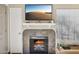 Close-up of the fireplace with decorative tile surround and mantel with TV above at 602 N May St # 29, Mesa, AZ 85201