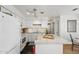 Bright kitchen with white cabinetry, modern lighting, and sleek countertops at 602 N May St # 29, Mesa, AZ 85201