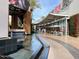 An outdoor mall featuring a water feature, landscaping, shops, restaurants, and outdoor seating at 602 N May St # 29, Mesa, AZ 85201