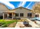 Backyard with covered patio, fire pit, and lush green lawn at 6461 S Kimberlee Way, Chandler, AZ 85249