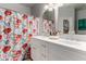 Bright bathroom features a double sink vanity and a decorative floral shower curtain at 6461 S Kimberlee Way, Chandler, AZ 85249