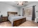 Cozy bedroom featuring wood-look tile flooring, a large window, and a neutral color scheme for a relaxing atmosphere at 6461 S Kimberlee Way, Chandler, AZ 85249