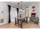 Warm and inviting dining area featuring a unique industrial style dining table, decorative accents, and ample natural light at 6461 S Kimberlee Way, Chandler, AZ 85249