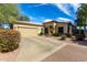 Charming single-story home with a well-maintained front yard, complemented by a two-car garage and desert landscaping at 6461 S Kimberlee Way, Chandler, AZ 85249