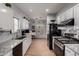 Contemporary kitchen with granite counters, stainless steel appliances, and white cabinets providing ample storage at 6461 S Kimberlee Way, Chandler, AZ 85249