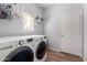 Clean laundry room with modern washer and dryer and built in shelving at 6461 S Kimberlee Way, Chandler, AZ 85249