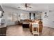 Spacious living room features a large window, a comfortable sectional sofa, and a ceiling fan for added comfort at 6461 S Kimberlee Way, Chandler, AZ 85249