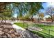 Neighborhood playground with walking paths and mature trees providing shade for children at 6461 S Kimberlee Way, Chandler, AZ 85249