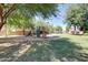 Community playground equipment with grassy lawns and shady trees for neighborhood  at 6461 S Kimberlee Way, Chandler, AZ 85249