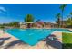 A refreshing community pool with lounge area and clear blue skies overhead on a sunny day at 6461 S Kimberlee Way, Chandler, AZ 85249