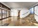 Bright living room featuring a staircase, shutters and stone tile flooring at 7025 E Panorama Dr, Cave Creek, AZ 85331