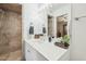 Well-lit bathroom featuring a walk-in shower and a vanity with ample counter space at 7313 E Bonita Dr, Scottsdale, AZ 85250