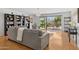 Comfortable living room showcasing a grey sectional sofa, built-in bookshelves, and sliding glass doors to the outdoor patio at 7313 E Bonita Dr, Scottsdale, AZ 85250