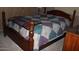Comfortable bedroom with a bed with a quilt and dark wood furniture at 7807 E Main St # F-30, Mesa, AZ 85207